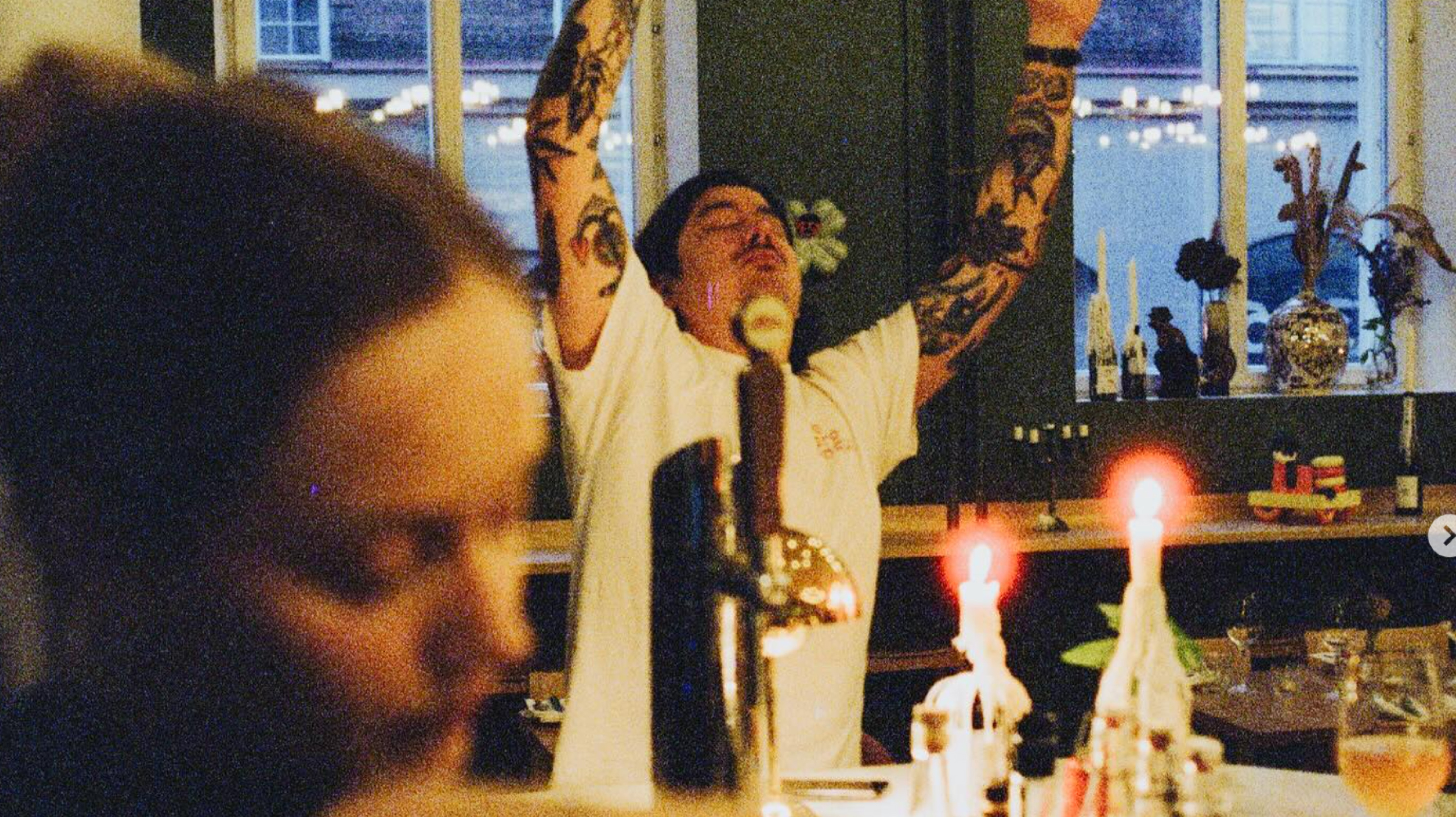 A bartender celebrating behind the counter