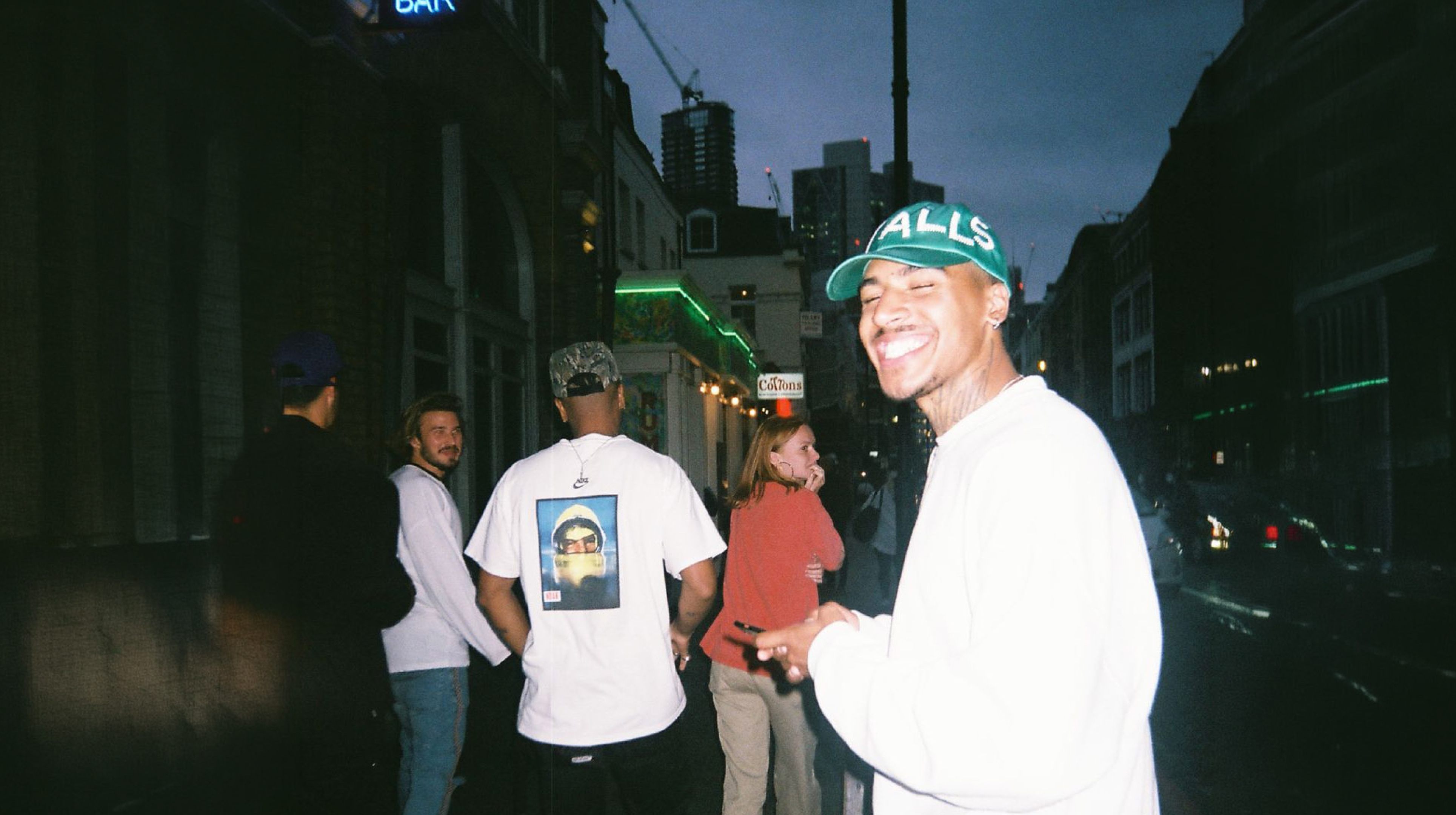 Friends laughing on a Helsinki street at night